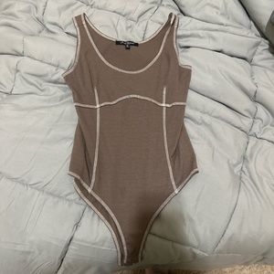 brown with white stitching body suit